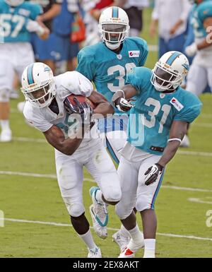 From left, Miami Dolphins wide receivers coach Josh Grizzard and