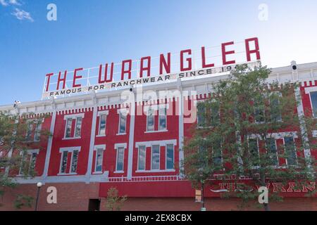 CHEYENNE, Wyoming - APRIL 27, 2018: Sign on top of The Wrangler in historic downtown Cheyenne Wyoming. The three story red-painted brick building domi Stock Photo