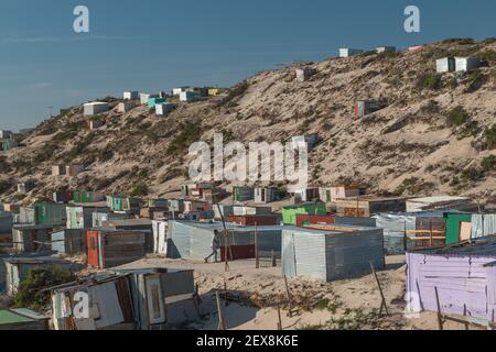 Township houses close to the sea in the sand dunes in Cape Town, South Africa Stock Photo