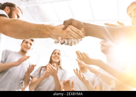 close up. a group of students applauding two opponents during a business briefing. Stock Photo