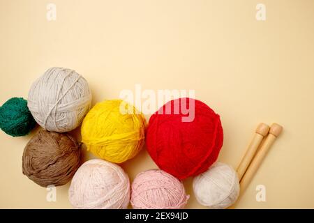 White and brown knitting wool and knitting needles on pastel background. Top view, flat lay, copy space Stock Photo