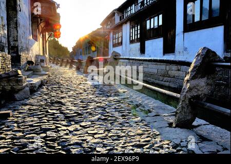 Morning light in Zhou Zhuang with cobblestone street and backlight Stock Photo