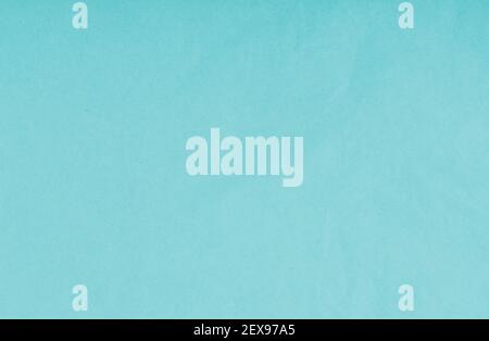 A rough-textured light blue grainy paper used as wallpaper or background with copy space Stock Photo