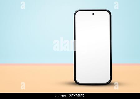 Blank smartphone standing on a pastel background with copy space Stock Photo