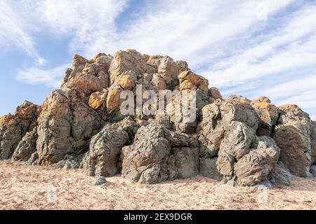 Volcanic rock outcrop at Llanddwyn Island, Newborough Beach, Anglesey, North Wales Stock Photo