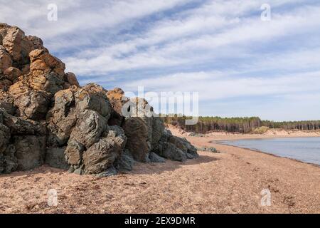 Volcanic rock outcrop at Llanddwyn Island, Newborough Beach, Anglesey, North Wales Stock Photo