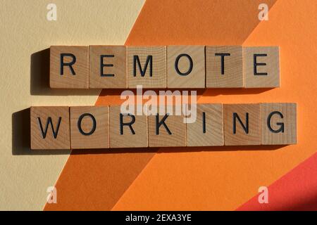 Remote Working, to work off site rather than in an office. Phrase in wooden alphabet letters. Stock Photo