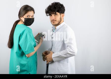 Doctors wearing mask and looking at camera Stock Photo