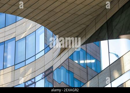 Düsseldorf (Kö-Bogen), Germany - March 1. 2021: Low angle view on curved ceiling of modern architecture building with glass window reflections Stock Photo