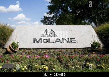 A logo sign outside of the headquarters of the McLane Group in Temple