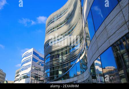 Düsseldorf (Kö-Bogen), Germany - March 1. 2021: View on new modern buildings with curved facade and window reflection of dark blue sky Stock Photo