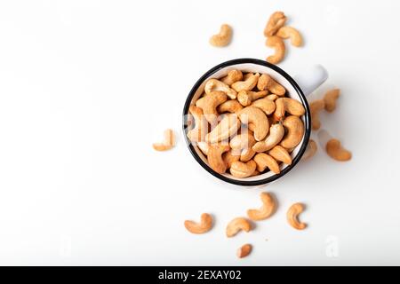 Cashew fruit in the white cup on  white background. Top view. Stock Photo