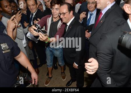 French President Francois Hollande poses for a selfie with a member of the public as he attends the 'Best Of France' Cultural Event in Times Square in New York, NY, on September 27, 2015. (Photo by Anthony Behar) *** Please Use Credit from Credit Field ***