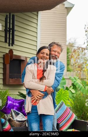 smile-portrait-and-hug-with-couple-in-home-for-bonding-marriage