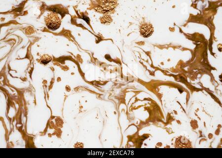 Ink bronze and gold glitter on white background.marble painting background with bronze and gold glitter splatter texture. Trendy wallpaper. ink Stock Photo