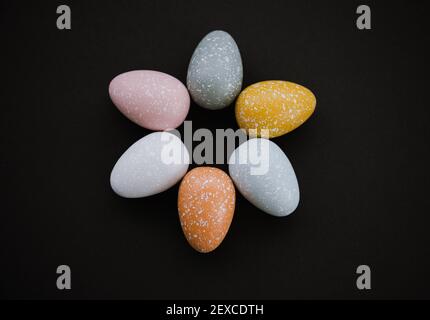 High angle overhead view of colored Easter eggs on black background Stock Photo