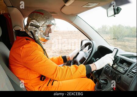 Man dressed as an astronaut using GPS Stock Photo