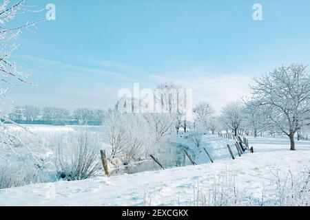 A snow-covered landscape in the winter sun Stock Photo