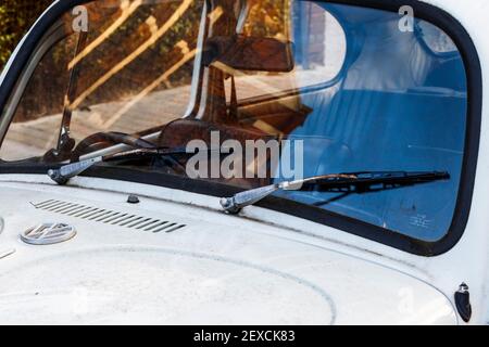 Close up of the windscreen and wipers of a dirty white-painted Volkswagen Beetle car, London, UK Stock Photo