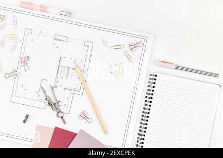 Blueprint flat project plan and office supplies on decorator table workspace. Swatches, tools and equipment background with copy space. Creative flat Stock Photo