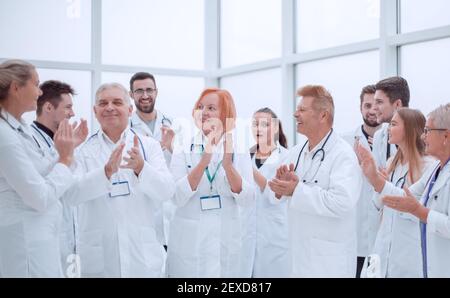 group of diverse smiling doctors applauding together. Stock Photo