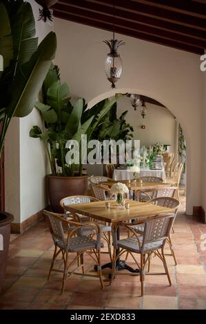 Room with chairs and table setting with candles, bouquets of flowers and plates Stock Photo