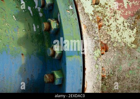 Rusty nuts and bolts, connecting two rusty old metal pipes. Stock Photo