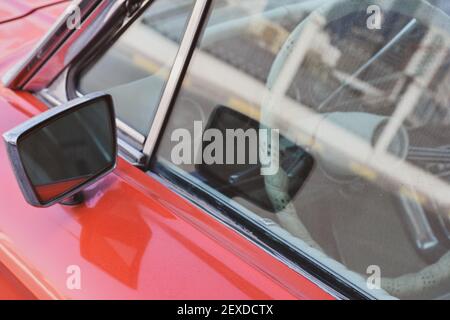 Close-up of red classic car side-view Mirror Stock Photo