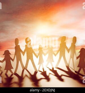 Family paper chain holding hands in front of sky. Bright future Stock Photo