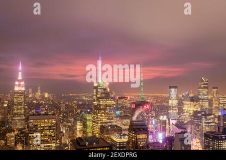 New York skyline from the top of  The rock observation deck in Rockefeller center at dusk  with clouds in the sky Stock Photo