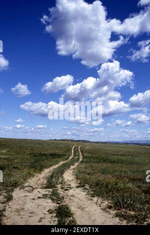 Old dirt road across prairie in the western United States. Stock Photo