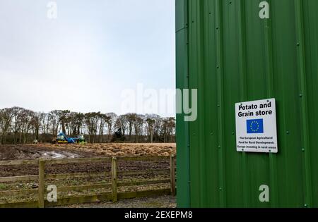 Potato and grain store with European Union flag for rural development, Luffness Mains Farm, East Lothian, Scotland, UK Stock Photo