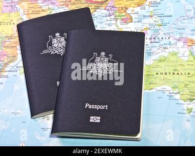 Australian Passport with the world map in the back Stock Photo