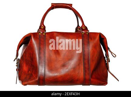 Beautiful red and brown leather bag with side fasteners, straps and brass buckles in vintage style on a white background. Stock Photo