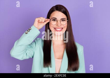 Photo of young happy cheerful beautiful charming businesswoman in glasses isolated on purple color background Stock Photo