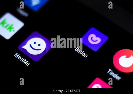 Madrid, Spain- March 3, 2021: Dating app icons on black screen in a smartphone. Tinder, Badoo, Meetme, Kik, Meetic app icons. Stock Photo