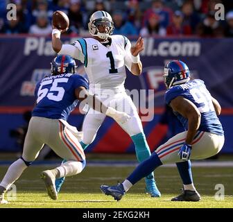 New York Giants' Eli Manning tries to get away from Denver Broncos' Robert  Ayers at MetLife Stadium in East Rutherford, New Jersey, Sunday, September  15, 2013. (Photo by Tyson Trish/The Record/MCT/Sipa USA