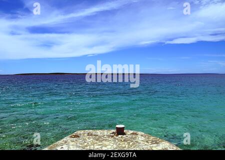 Beautiful seascape and aerial view of the horizon line between turquoise sea water and blue sky with white clouds on a sunny summer day Stock Photo