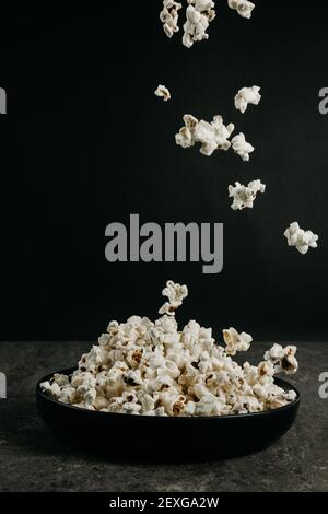 falling pop corn on black background Stock Photo