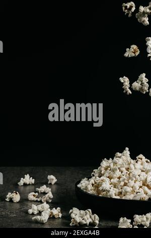 falling pop corn on black background Stock Photo