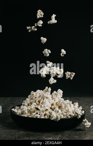 falling pop corn on black background Stock Photo