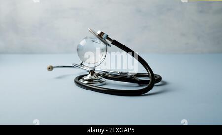 Global healthcare, Worldwide medical science, wellness business, pandemic concept. Crystal glass world globe and stethoscope on blue background Stock Photo