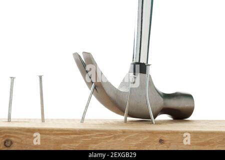 Nail being pulled out of wooden plank Stock Photo