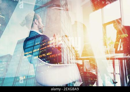Hipster business man in elegant suit is on business meeting in the office. Double exposure effects Stock Photo