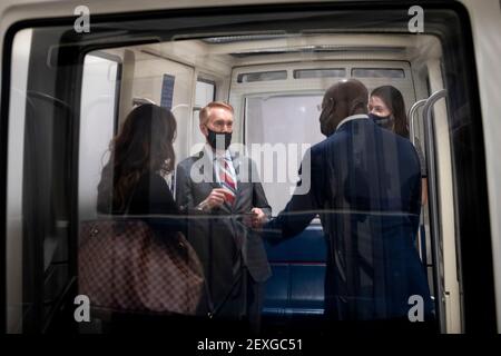 United States Senator James Lankford (Republican of Oklahoma), left, talks with United States Senator Raphael G. Warnock (Democrat of Georgia), right, on a Senate subway train following a vote at the U.S. Capitol in Washington, DC, Thursday, March 4, 2021. Credit: Rod Lamkey/CNP Stock Photo