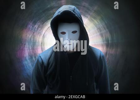 Masked anonymous hacker in tunnel. Internet security concept. Stock Photo