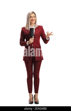 Full length portrait of a female reporter with a microphone gesturing with hand isolated on white background Stock Photo