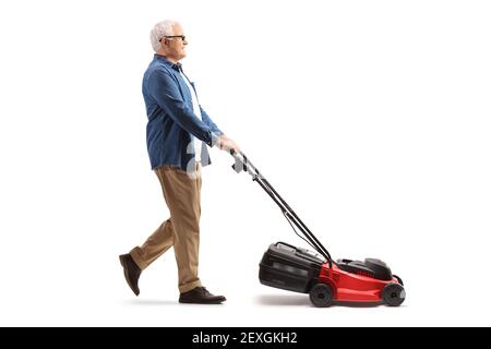 Full length profile shot of a mature man mawing with a lawnmower machine isolated on white background Stock Photo