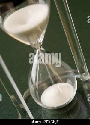 Sand Falls Down Through a Crystal Hour Glass Stock Photo