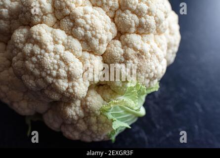 Close up of a head of cauliflower on a black background. Stock Photo